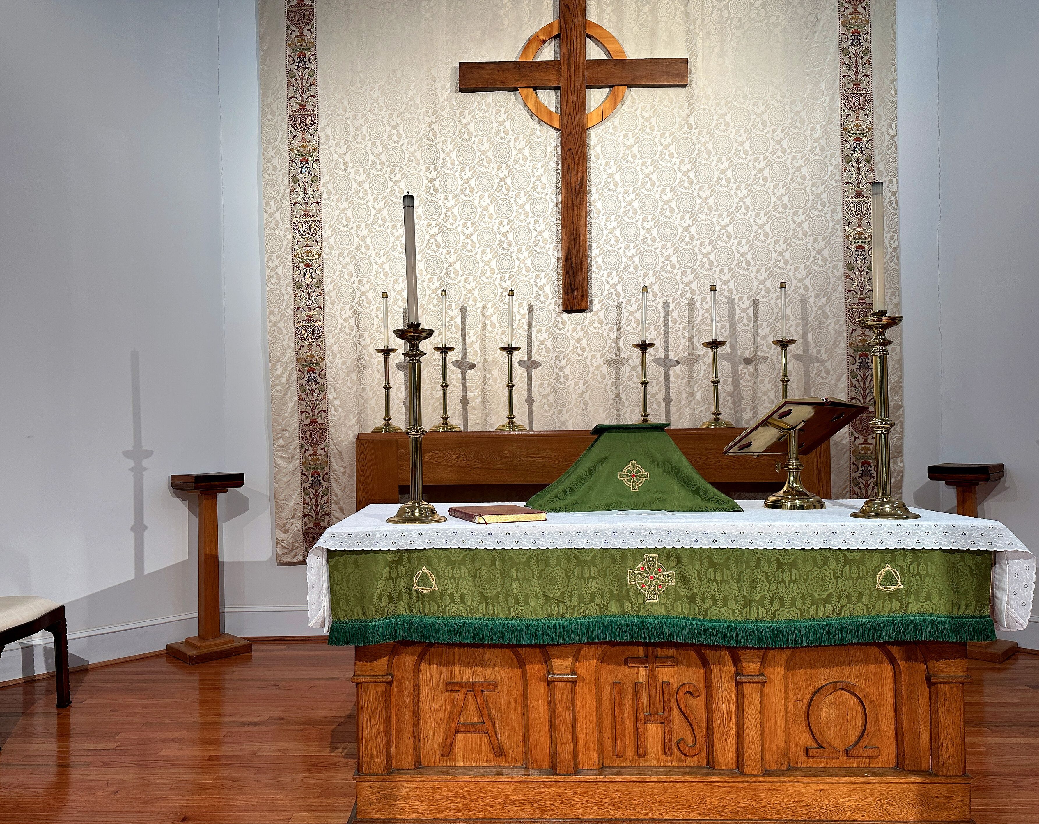 a wooden alter with a cross on the wall